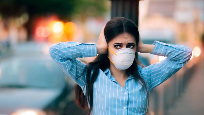 78033662 - girl with mask covering her ears because of noise pollution